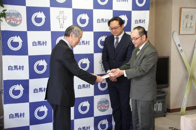 寄附金を受け取る村長